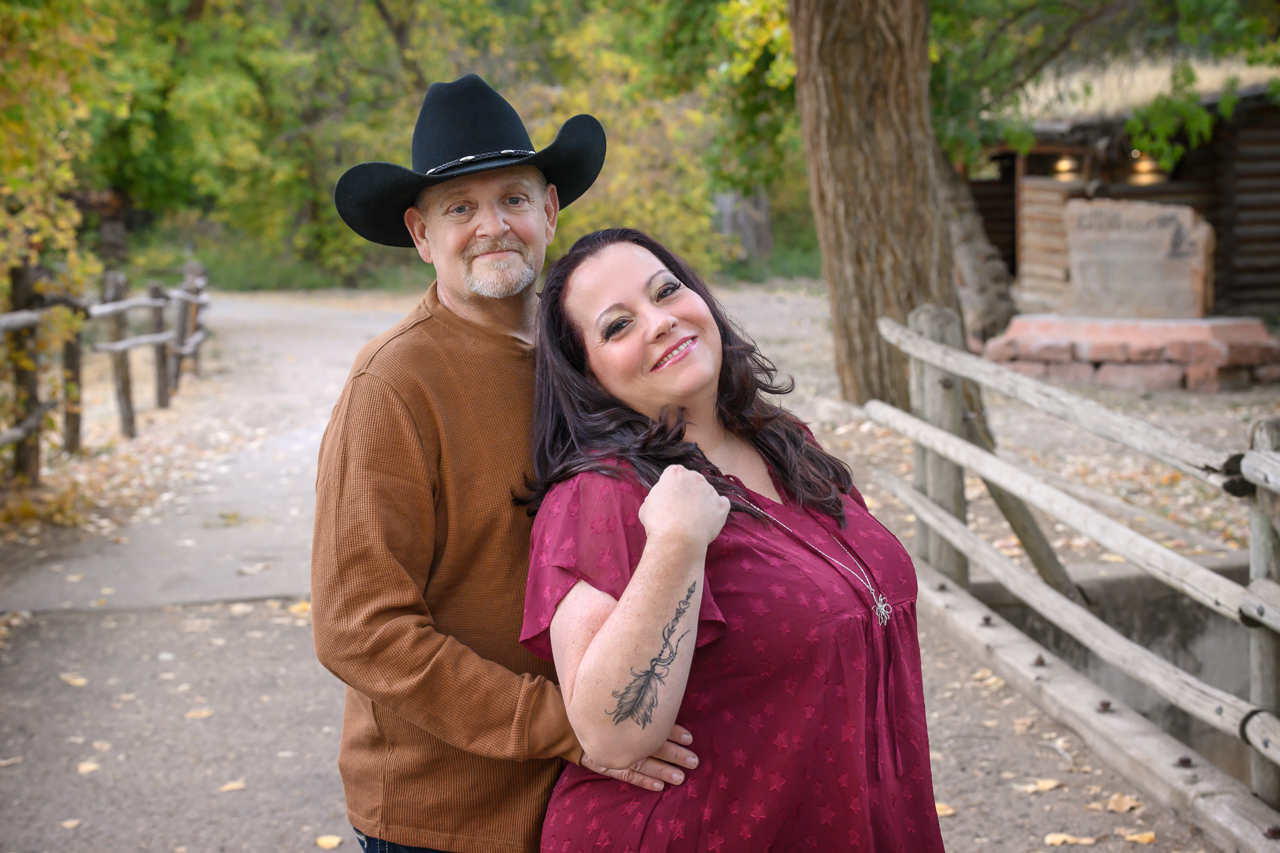 family location, couple, parents, fall mini Parents embracing during extended family photo session in North Ogden Utah, on a fall pathway