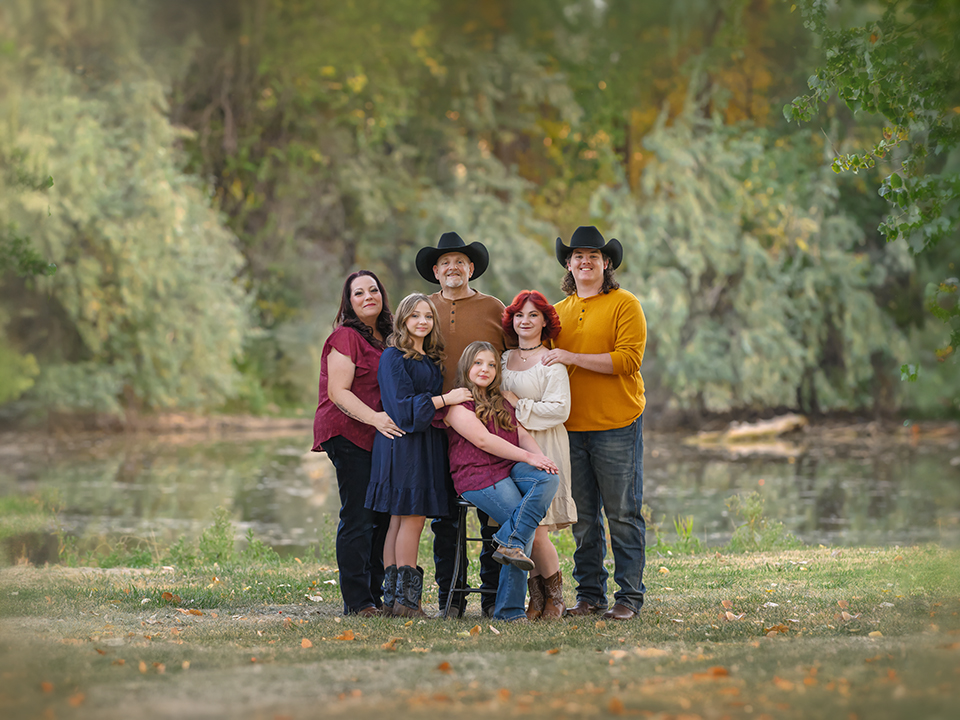 Family_North-Ogden-Photographer Outdoor family portrait in North Ogden Utah by La Bella Sole Photography, featuring an extended family posing near a wooded pond
